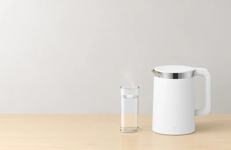Mi Smart Kettle Pro compact electric kettle beside steaming glass