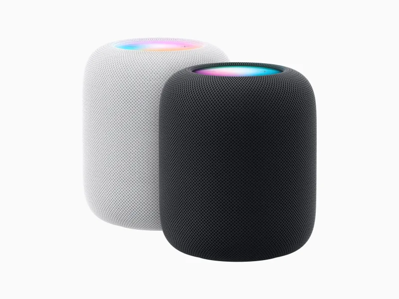 Apple HomePod speakers in white and dark finishes with illuminated top surfaces