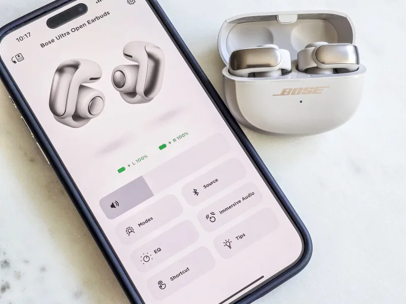 Bose Ultra Open Earbuds with Bose Music app screen on phone