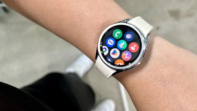 Samsung Galaxy Watch6 Classic on wrist showing app icons interface