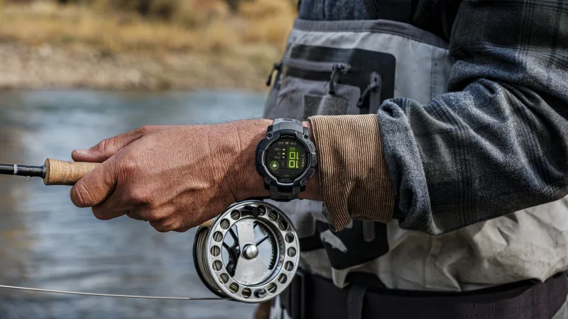 Garmin Instinct 3 AMOLED screen showing fishing metrics outdoors