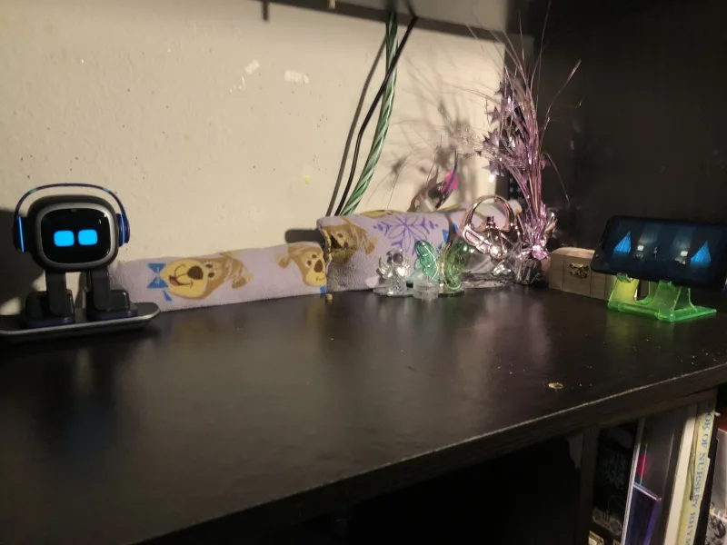 LivingAI EMO robot with digital face on desk setup