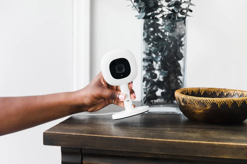 Nanit Pro camera held in hand for quick setup