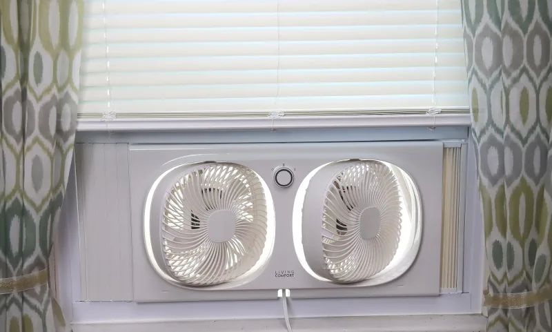 Comfort Zone 9-inch twin window fan showing dual-fan reversible design