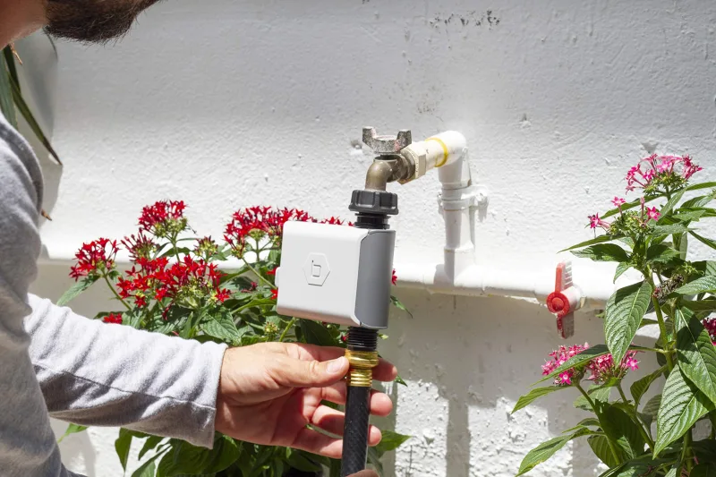 B-hyve Smart Hose Timer attached to outdoor spigot during installation