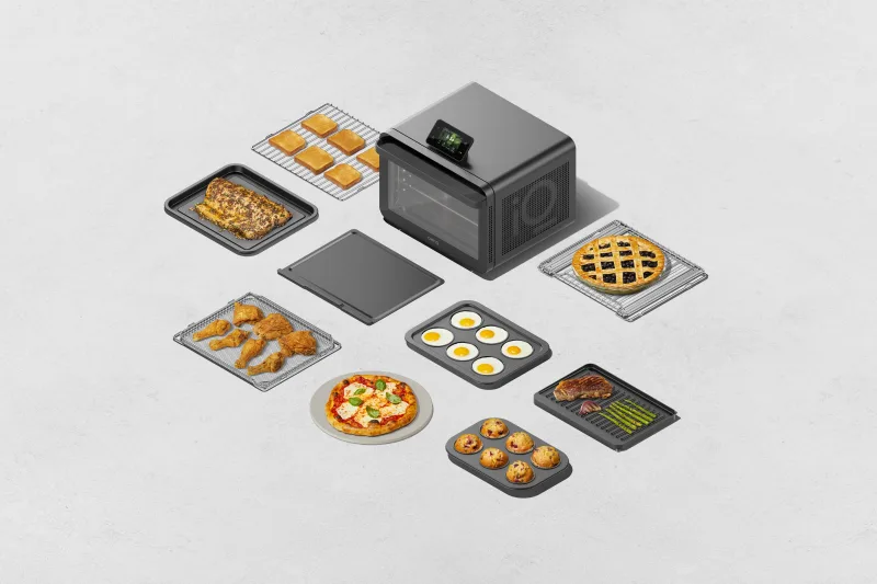 CHEF iQ MiniOven countertop oven with accessories and multiple cooked dishes