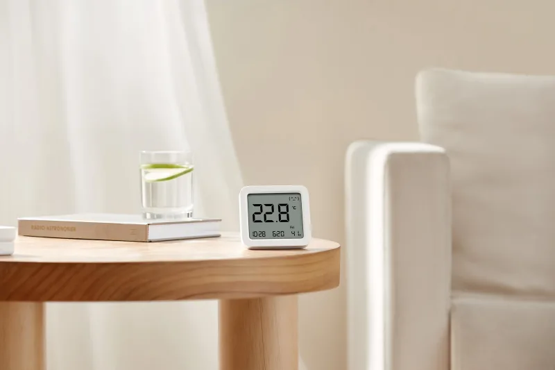 Xiaomi Smart Temperature and Humidity Monitor 3 front-facing product shot with compact square shape and adhesive mount