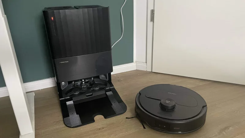 Roborock Qrevo Master robot vacuum next to docking station