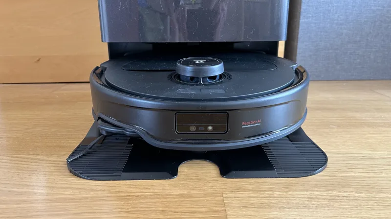 Roborock Qrevo Master robot vacuum navigating around obstacles in a room